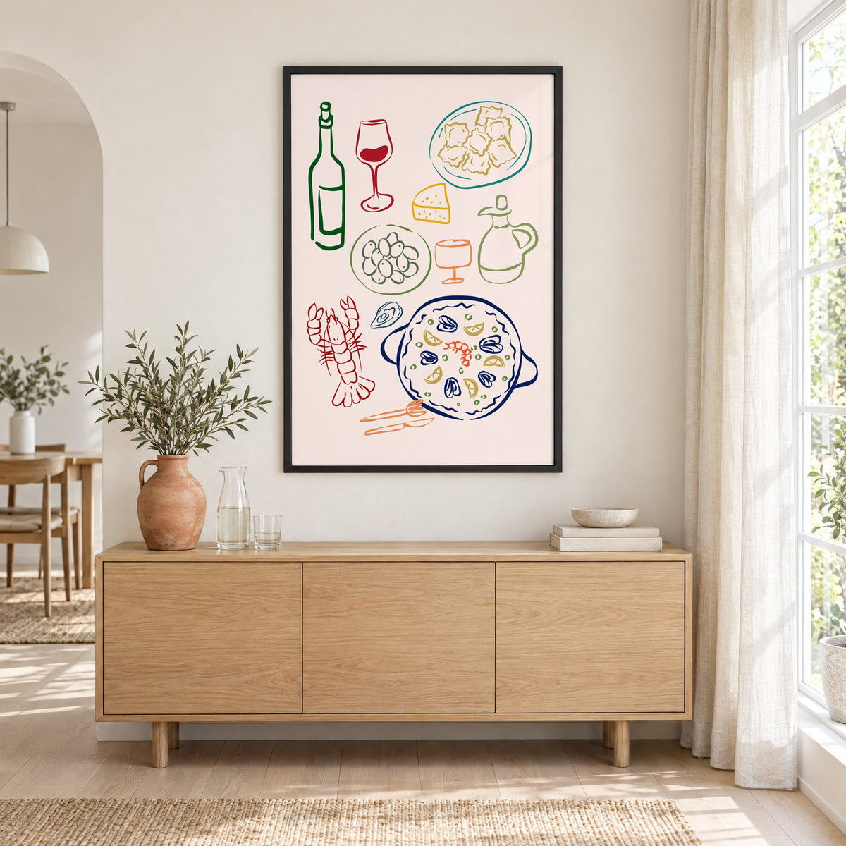 Line art paella wine olives print in a black frame above an oak sideboard with a terracotta vase of olive branches
