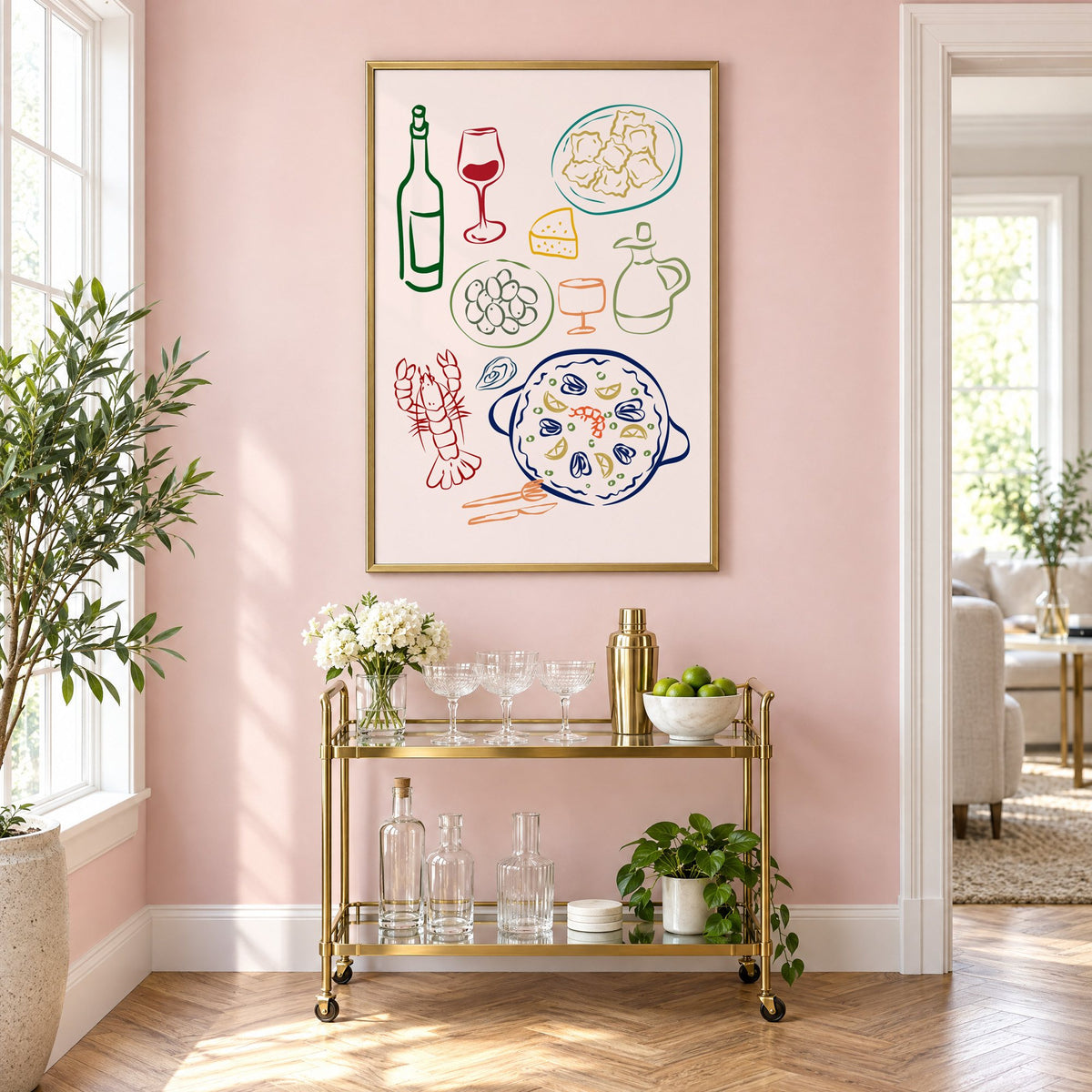 Line art paella wine olives print in a brass frame above a gold bar cart on a blush pink wall