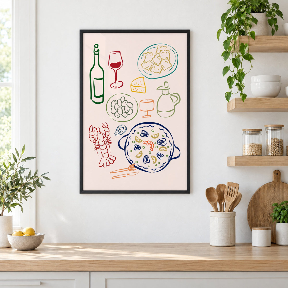 Line art paella wine olives print in a black frame in a white kitchen beside open wood shelves and glass jars