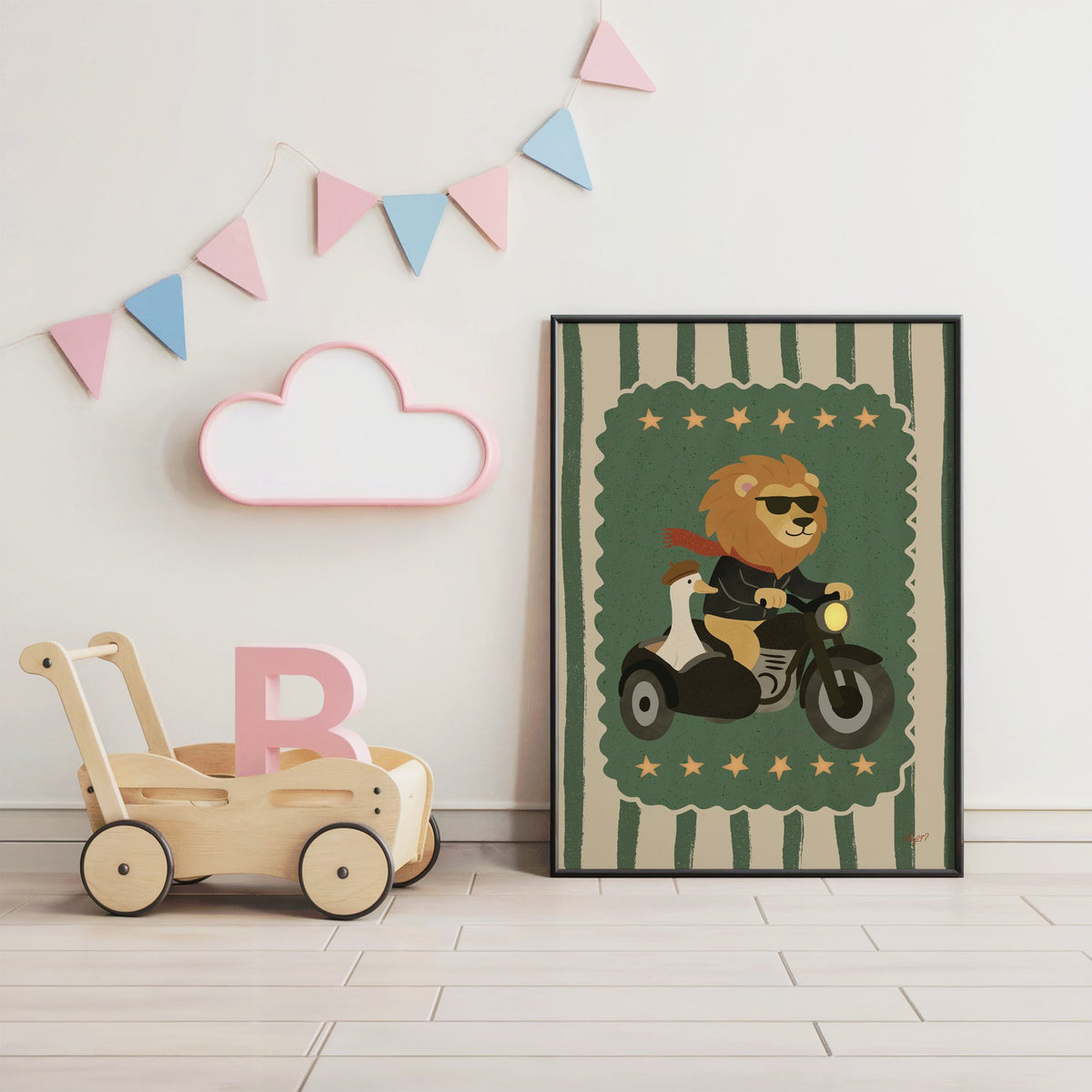 Lion on motorcycle with goose sidecar nursery print in a black frame under pastel bunting by a wooden baby walker