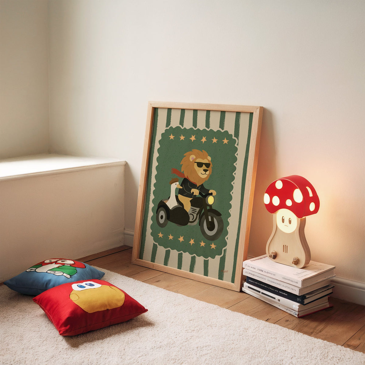 Lion on motorcycle with goose sidecar nursery print in an oak frame leaning on a rug beside a mushroom lamp and floor