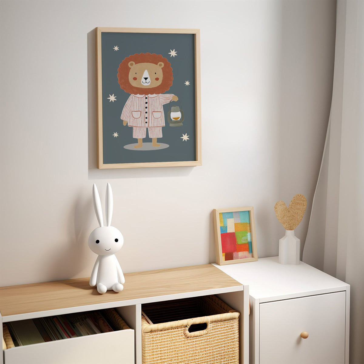 Lion in pajamas with lantern nursery print in an oak frame above a kids cubby shelf with a woven basket and bunny lamp