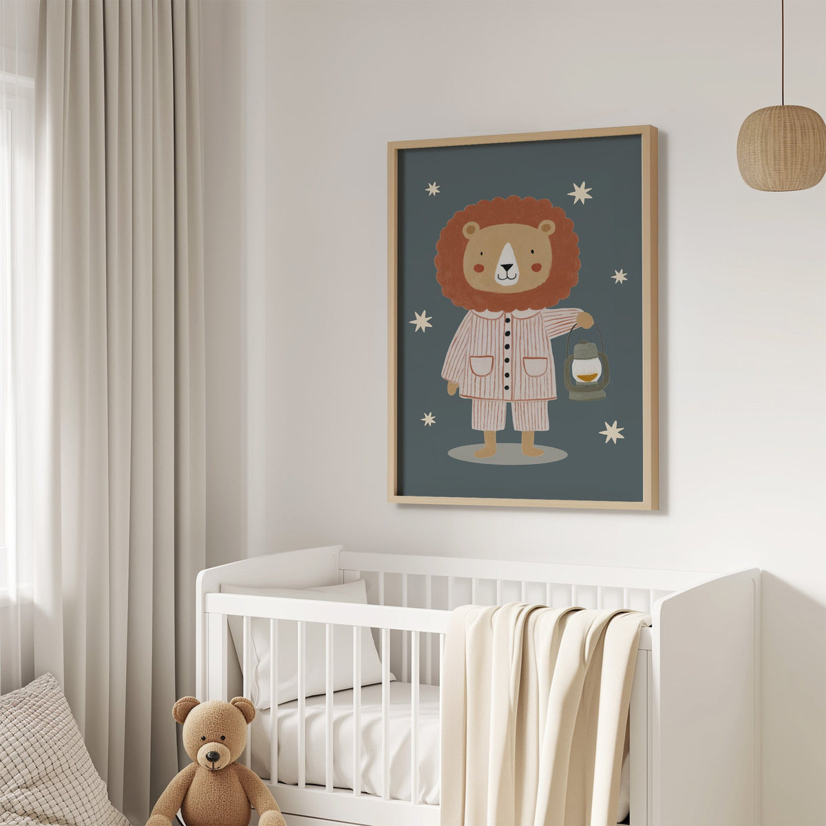 Lion in pajamas with lantern nursery print in an oak frame above a white crib with a teddy bear