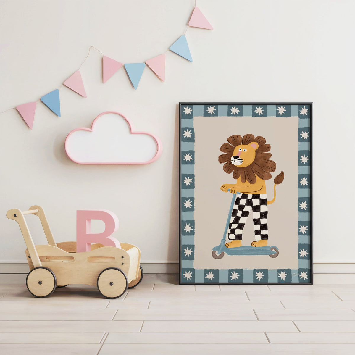 Lion on scooter in checkered pants nursery print in a black frame under pastel bunting by a wooden baby walker