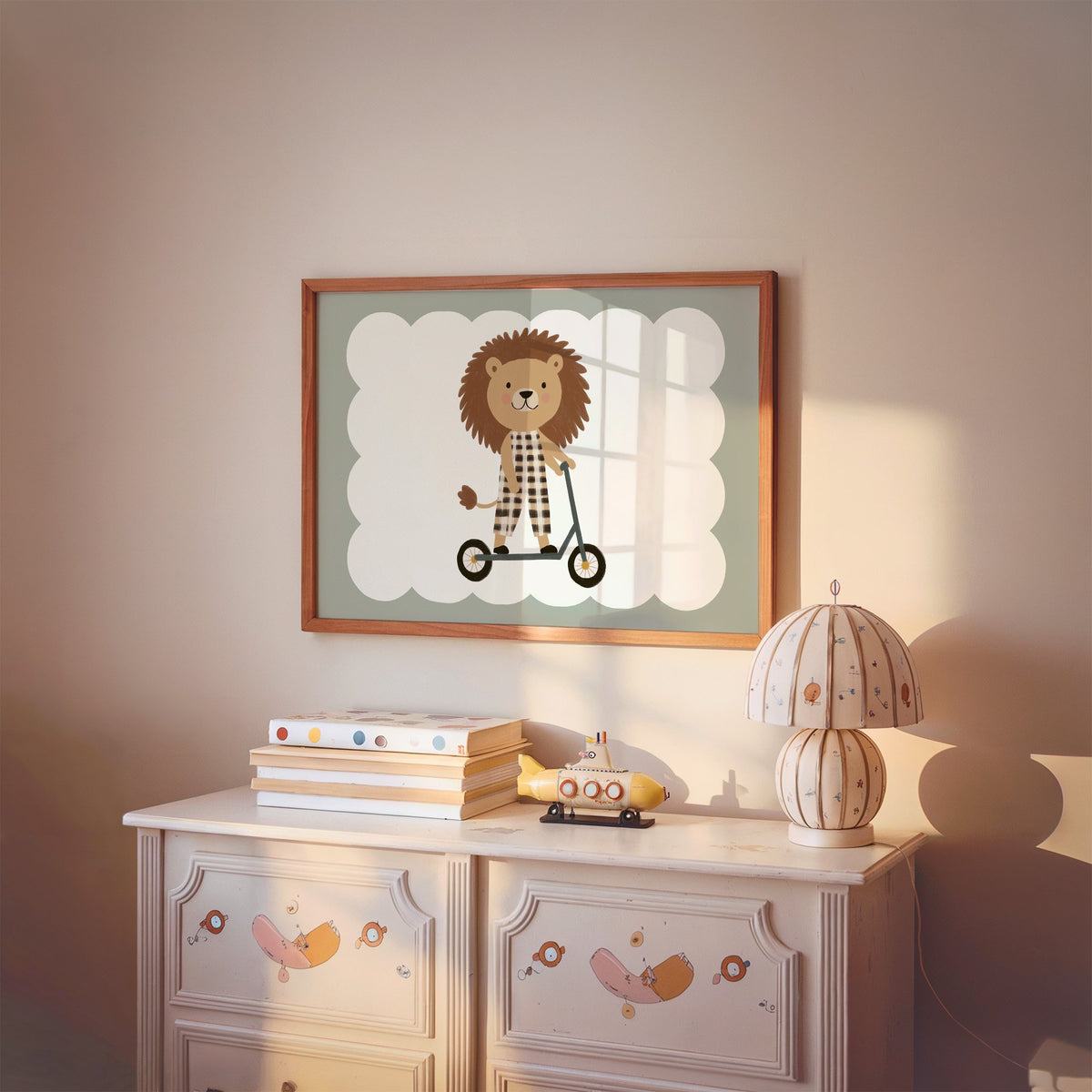 Landscape lion on scooter gingham nursery print in a cherry wood frame above a painted dresser and lamp