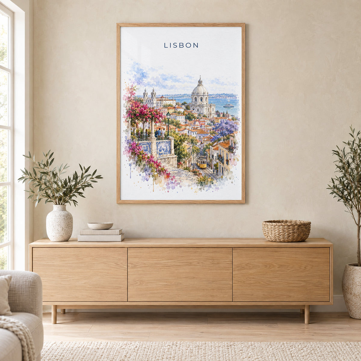 Lisbon watercolor print in an oak frame above a light wood sideboard in a Scandinavian living room