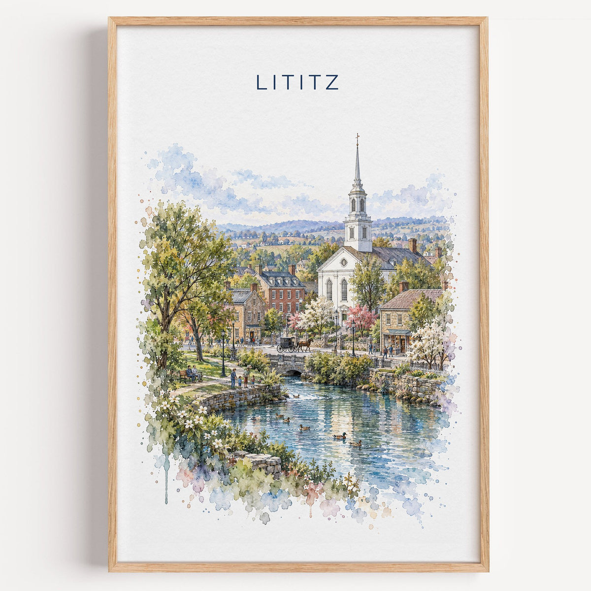 Lititz, Pennsylvania watercolor print in a light oak frame on a plain white wall
