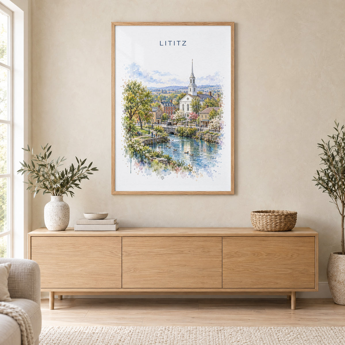 Lititz, Pennsylvania watercolor print in an oak frame above a light wood sideboard in a Scandinavian living room