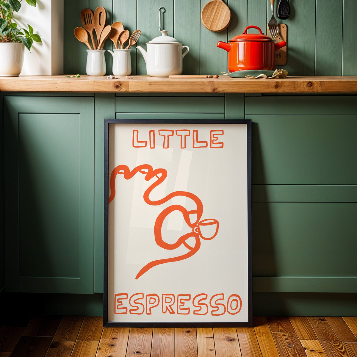 Little espresso one line print in a black frame against sage green kitchen cabinets