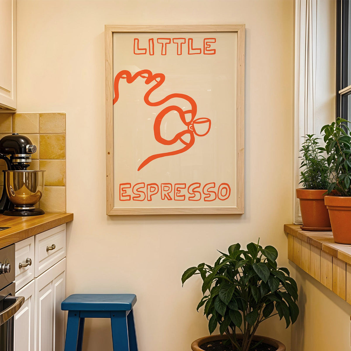 Little espresso one line print in a wood frame on a yellow tiled kitchen wall