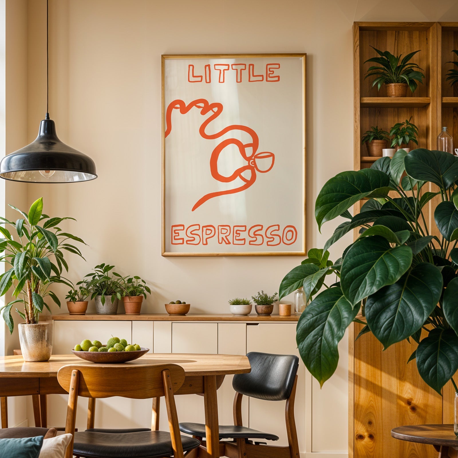 Little espresso one line print in an oak frame above a sideboard in a plant-filled dining room