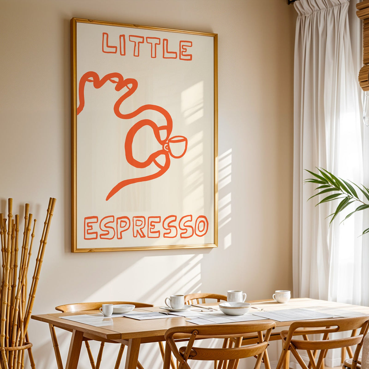Little espresso one line print in a gold frame above a sunlit breakfast table