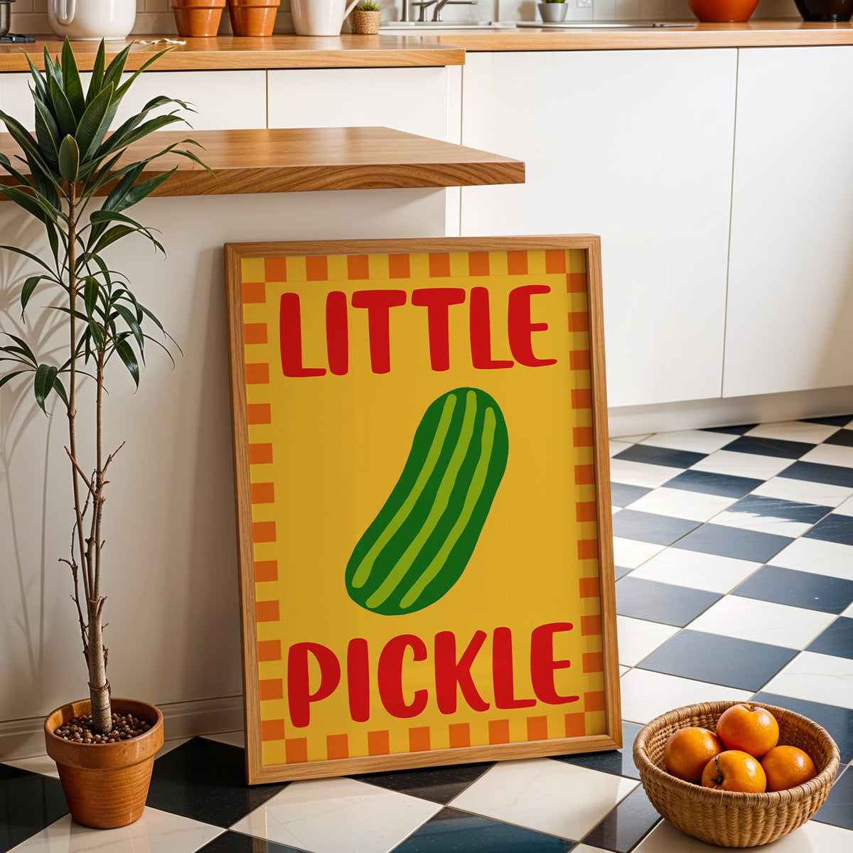 Little pickle print in an oak frame by a kitchen island and checkered floor