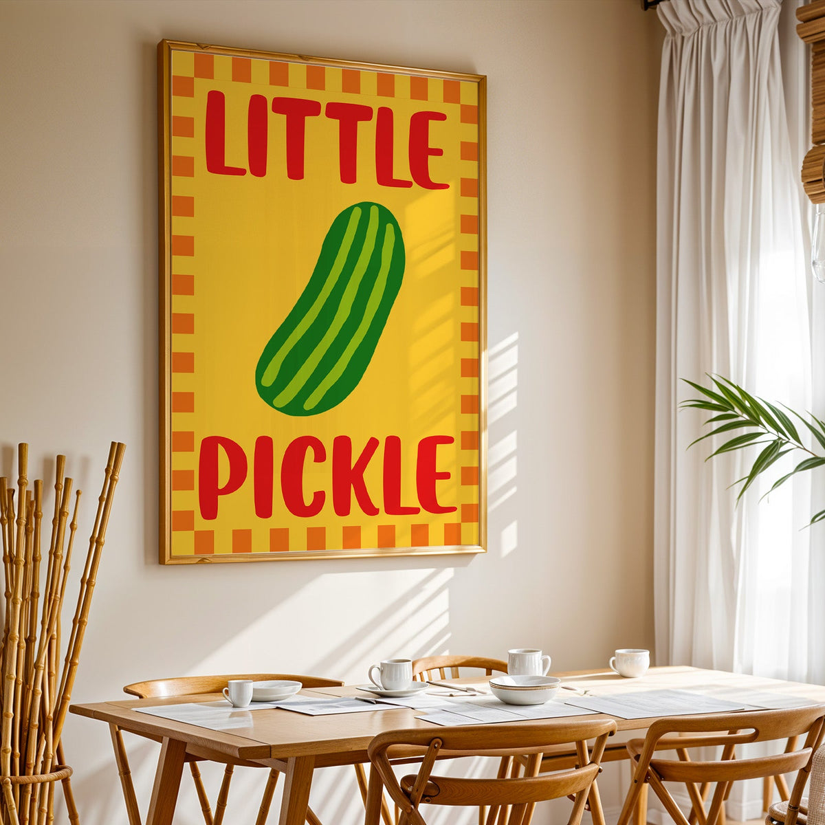 Little pickle print in a gold frame above a sunlit breakfast table