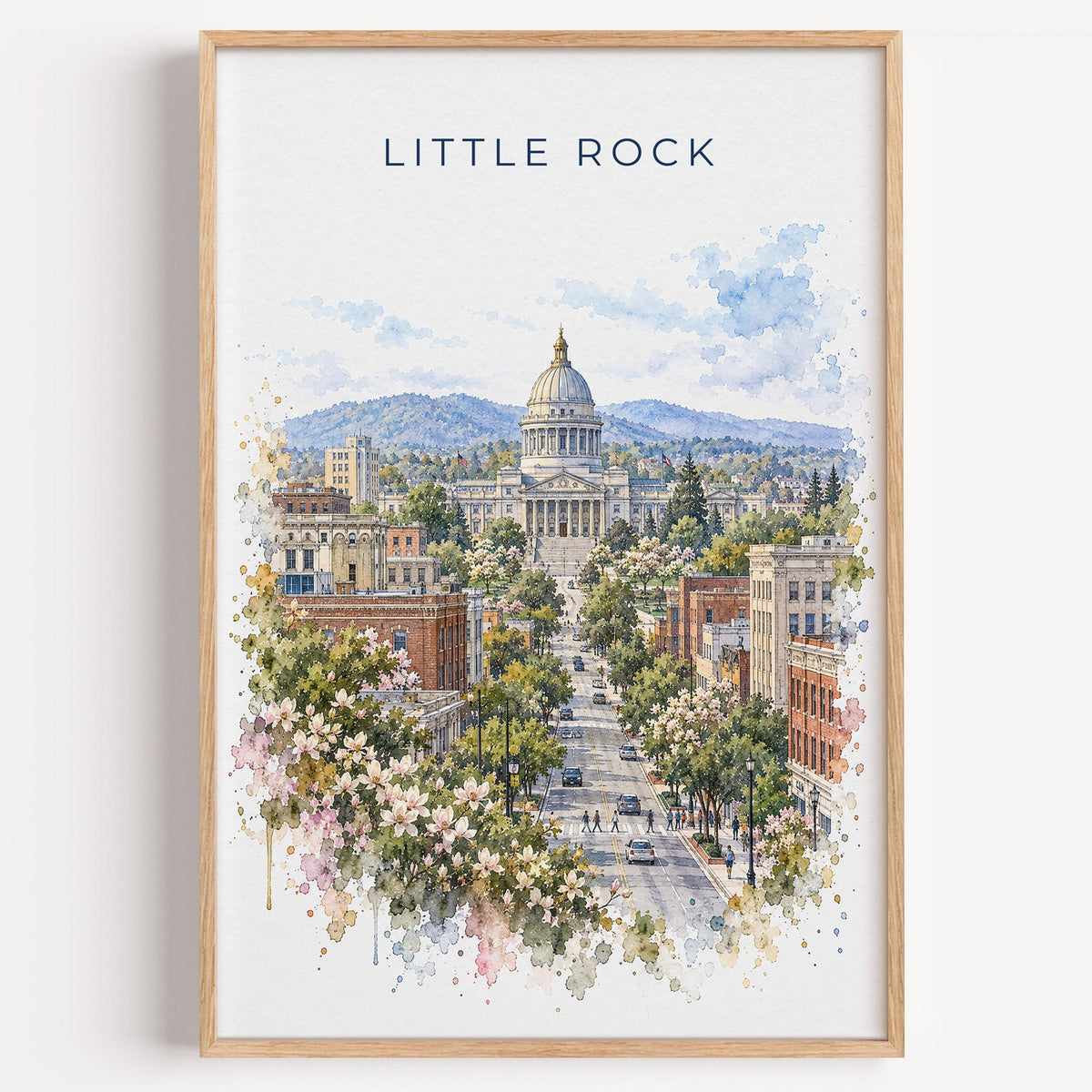 Little Rock watercolor print in a light oak frame on a plain white wall