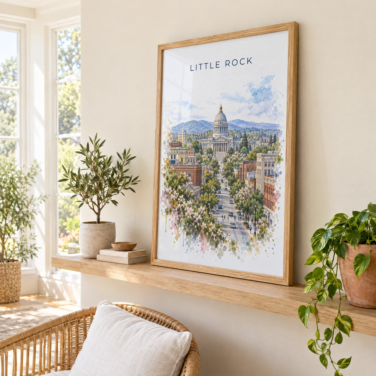 Little Rock watercolor print in an oak frame on a picture ledge in a sunlit sunroom