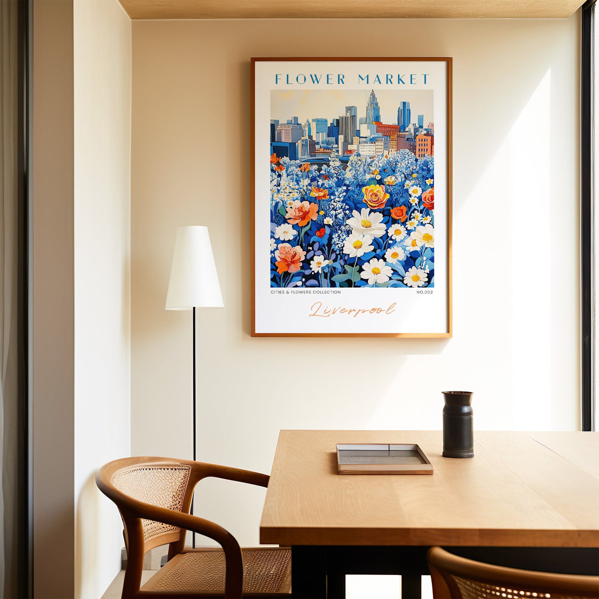Liverpool flower market print in an oak frame above a dining table and cane chair