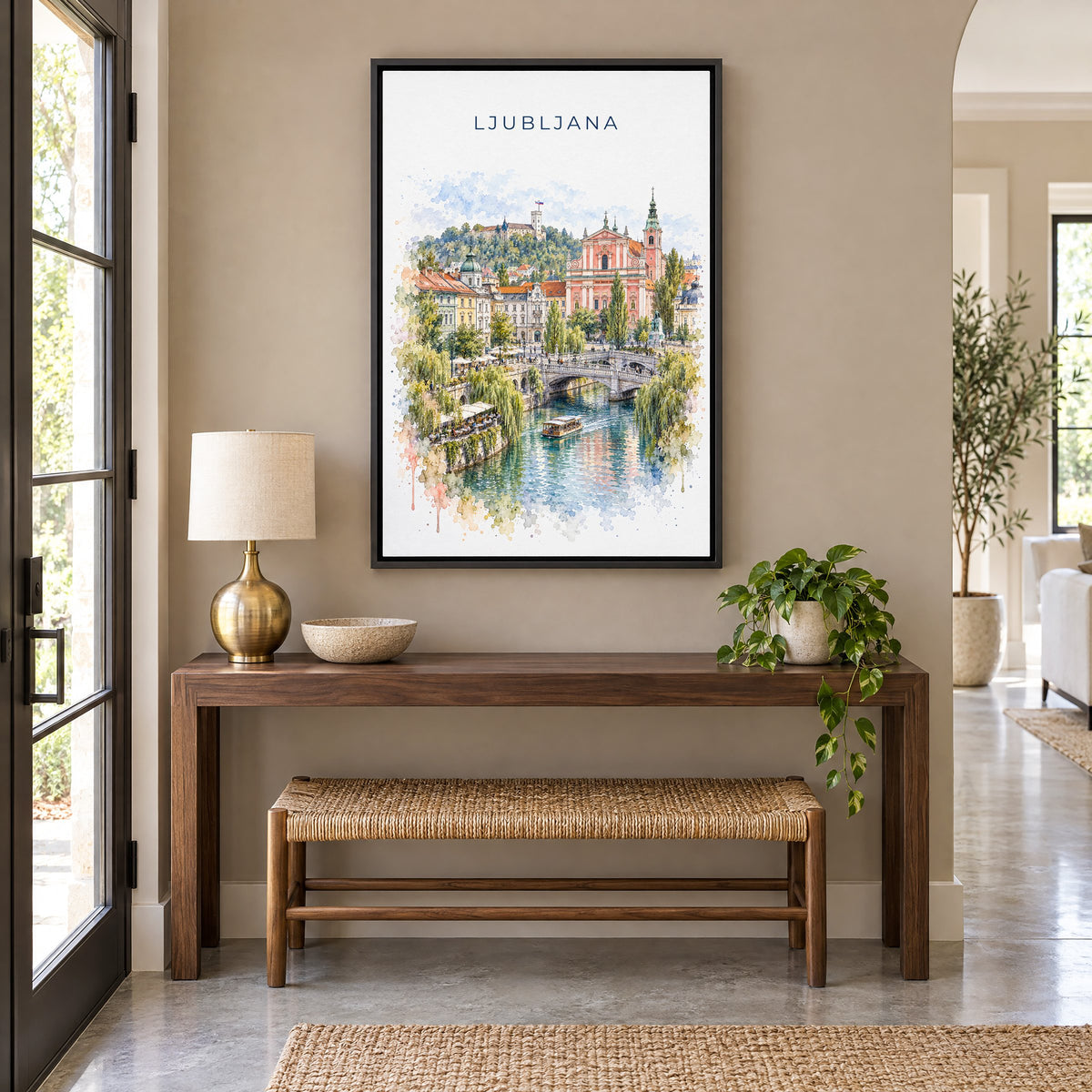 Ljubljana watercolor print as a black floater canvas above a walnut console and woven bench in an entryway