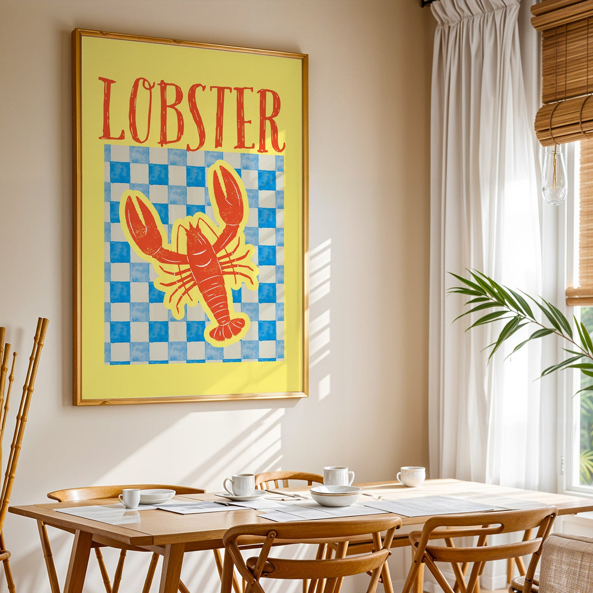 Lobster blue check print shown in a gold frame above a breakfast table by a curtained window