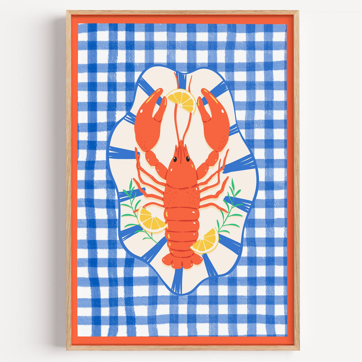 Lobster on blue gingham print in a light oak frame on a plain white wall