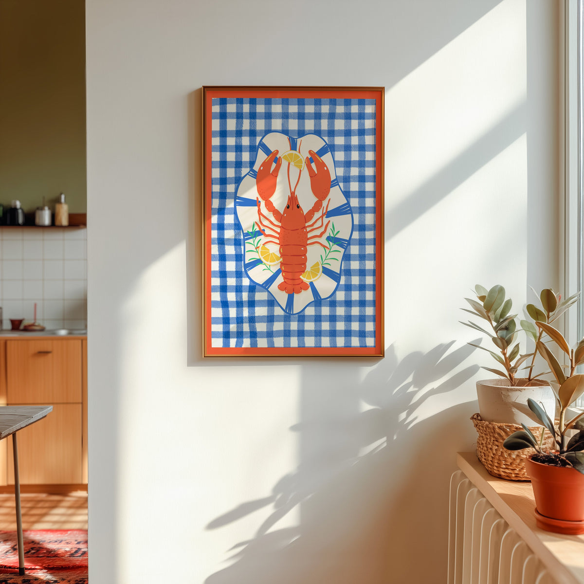Lobster gingham print shown in a gold frame in sunlight with plants and a kitchen beyond