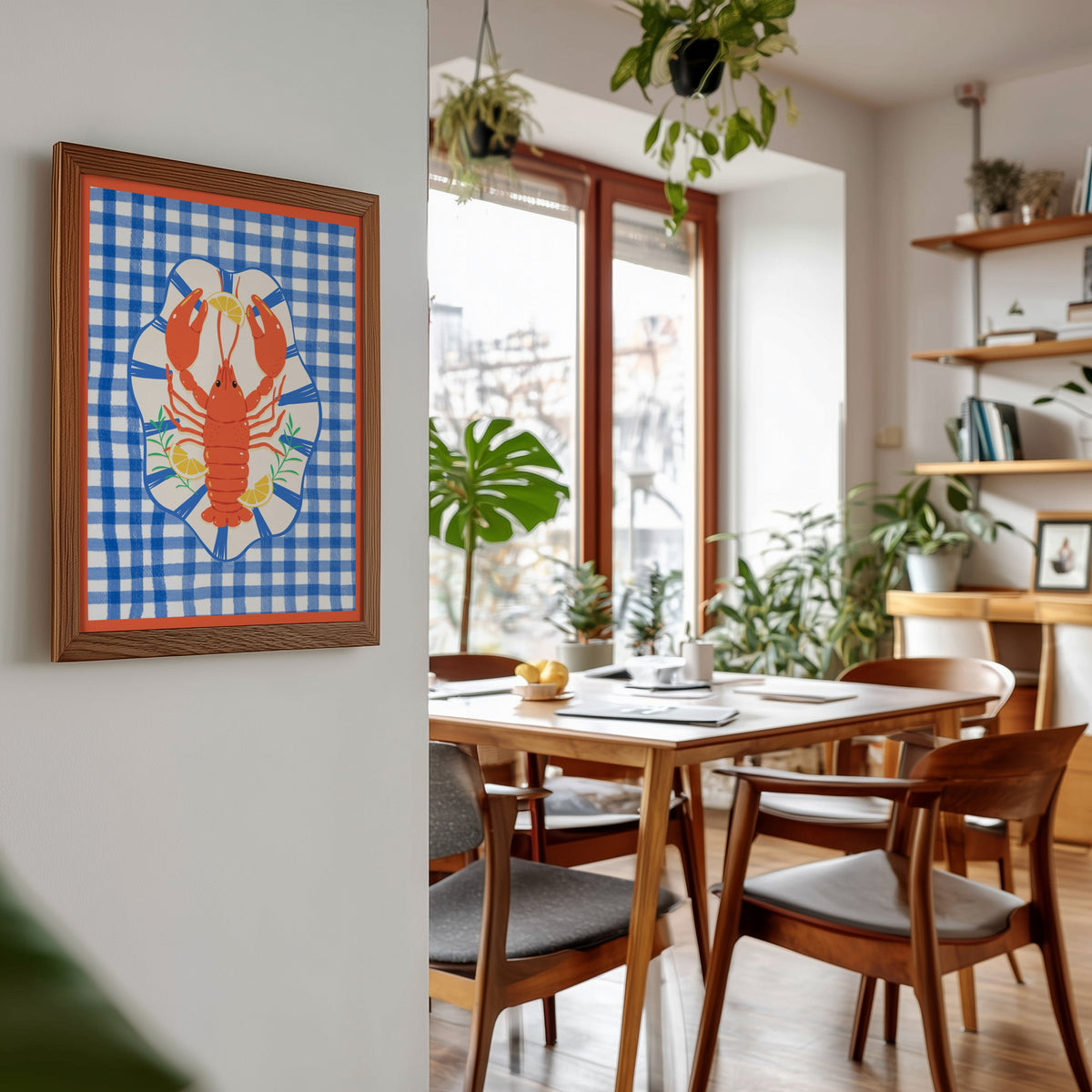 Lobster gingham print in a walnut frame beside a mid-century dining table