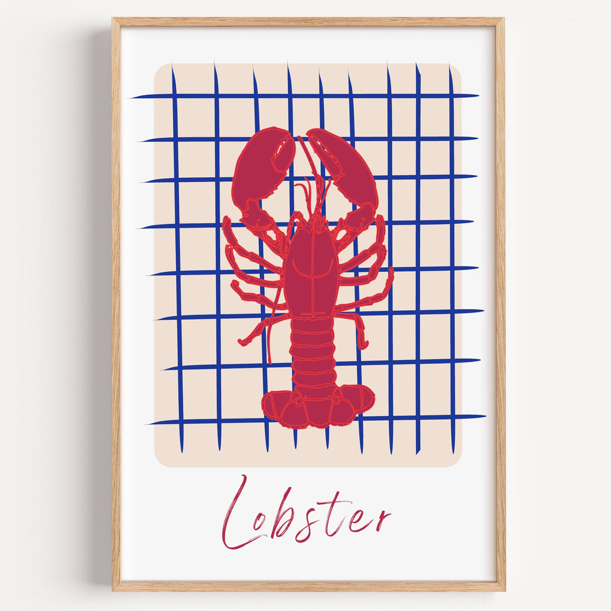 Lobster on cobalt grid print in a light oak frame on a plain white wall