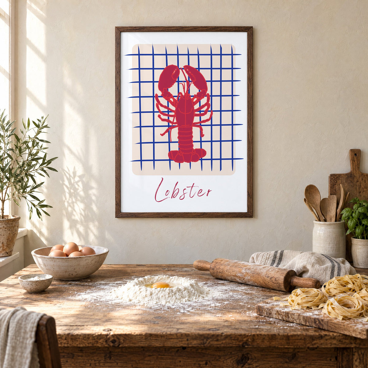 Lobster on cobalt grid print in a walnut frame above a rustic table set for making fresh pasta