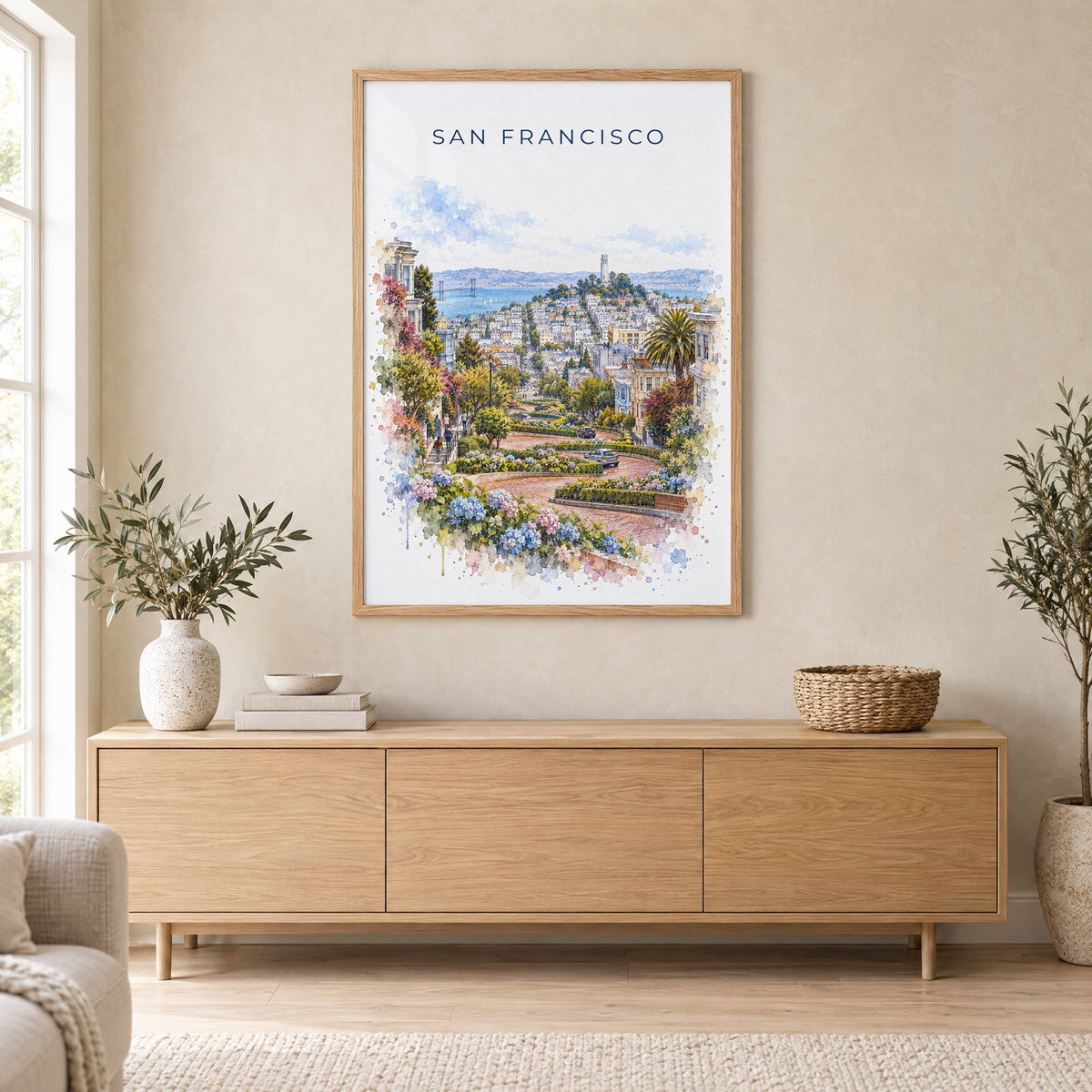 Lombard Street San Francisco watercolor print in an oak frame above a light wood sideboard in a Scandinavian living room