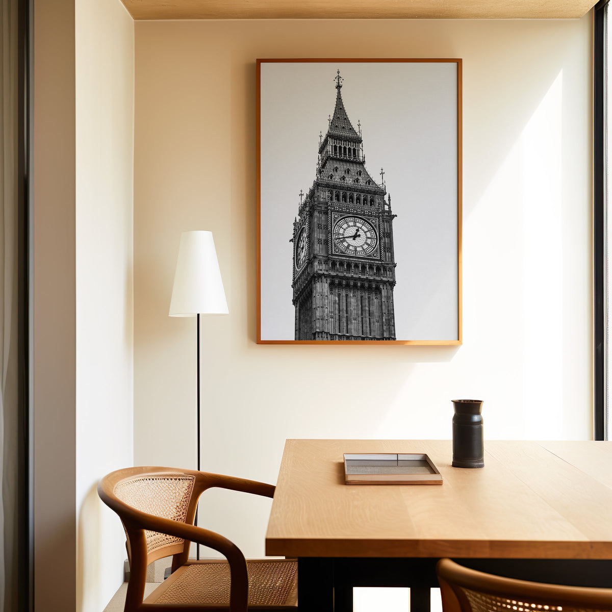 Big Ben clock tower low-angle photo print in an oak frame above a dining table and cane chair