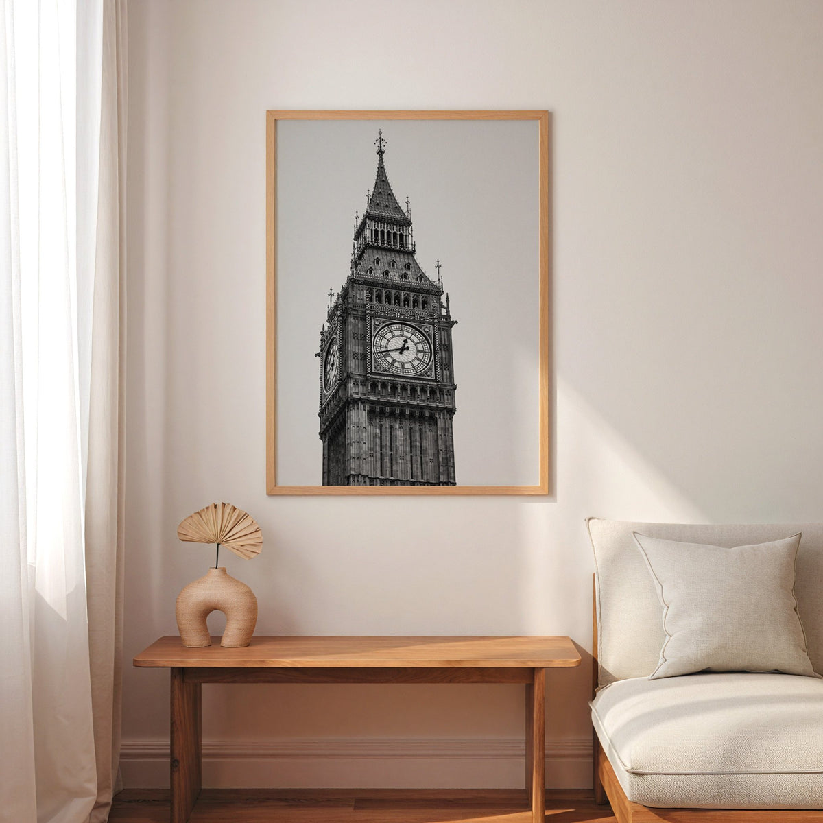 Big Ben clock tower low-angle photo print in an oak frame above a narrow console with an arched vase