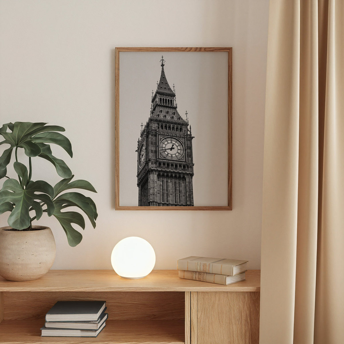 Big Ben clock tower low-angle photo print in a walnut frame above an oak cabinet with a glowing globe lamp