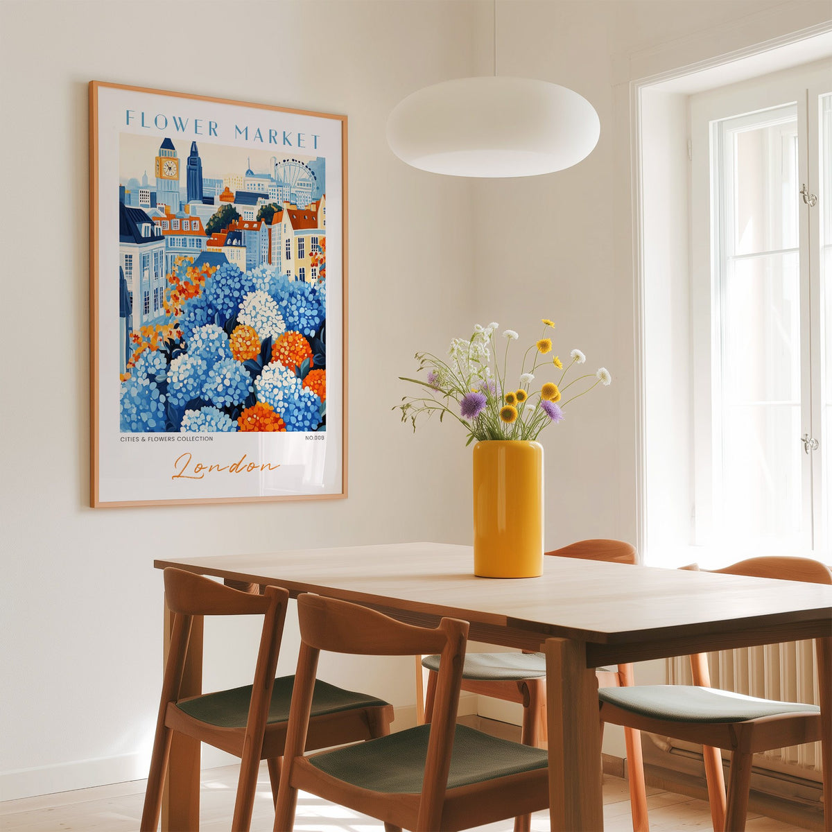 London flower market print in an oak frame above a dining table with a yellow vase and white pendant light
