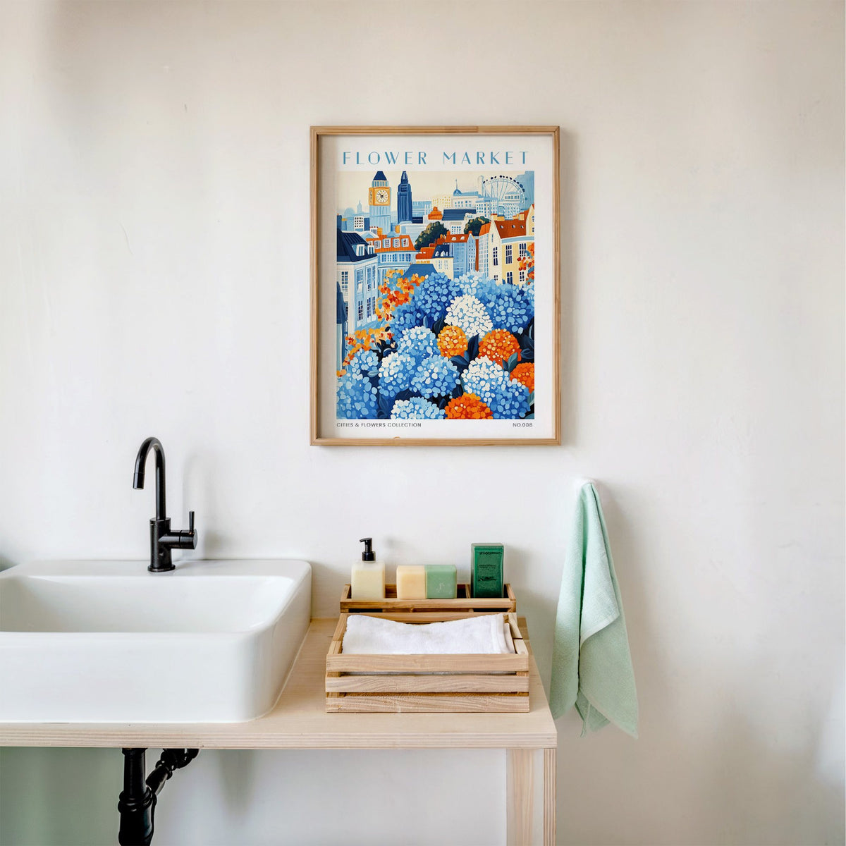 London flower market print in an oak frame above a white bathroom sink with folded towels