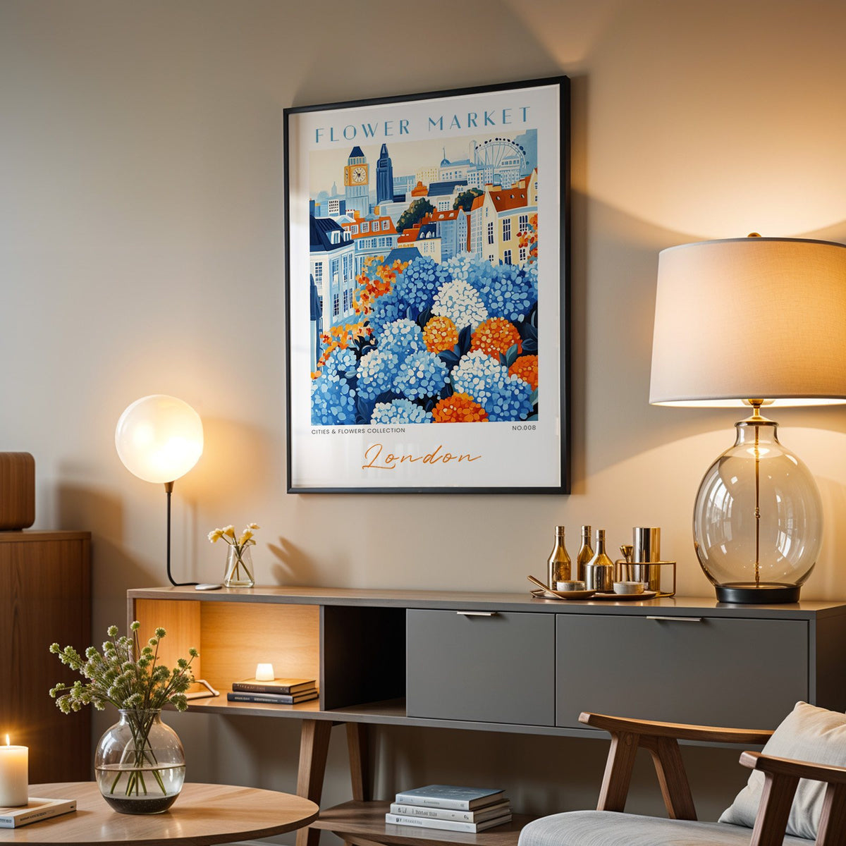 London flower market print in a black frame above a grey media console with a glass table lamp