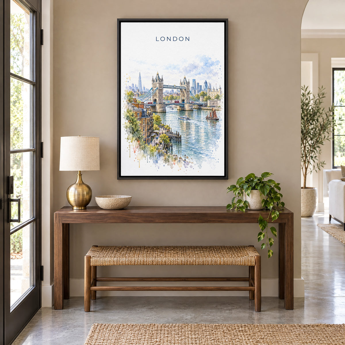 London watercolor print as a black floater canvas above a walnut console and woven bench in an entryway