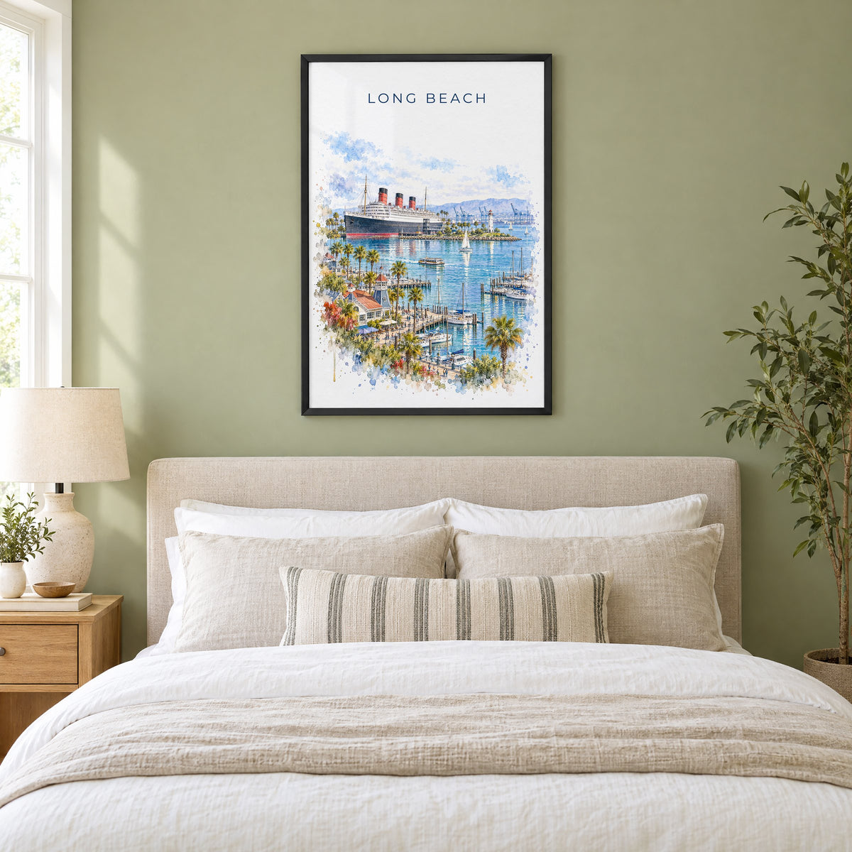 Long Beach watercolor print in a black frame above an upholstered headboard in a sage green bedroom