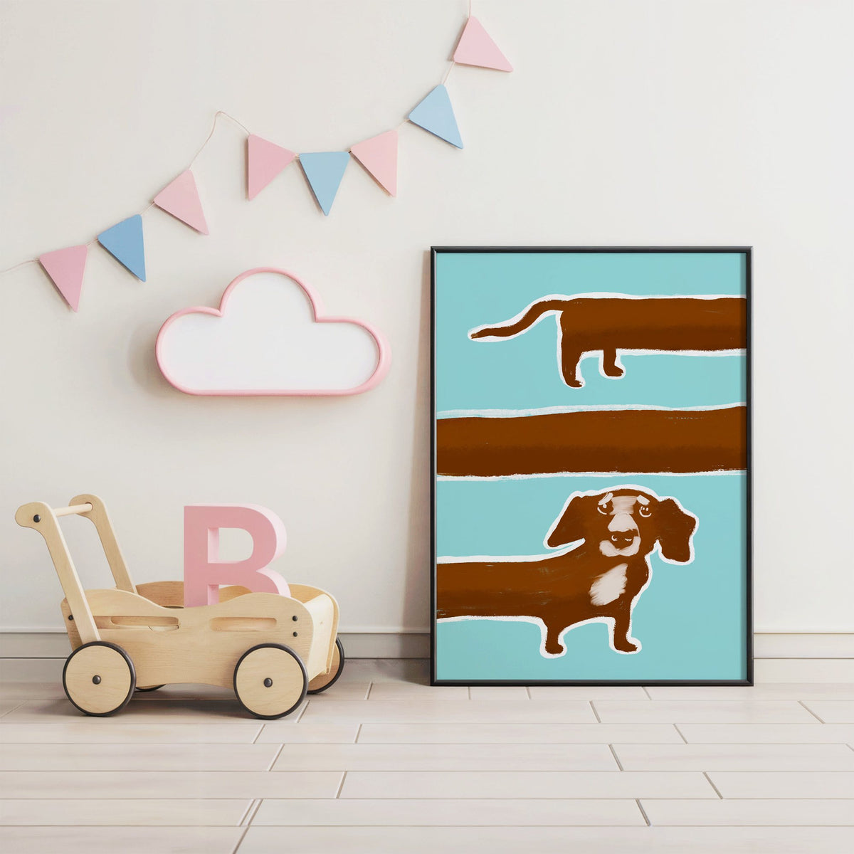 Extra long dachshund in three rows nursery print in a black frame under pastel bunting by a wooden baby walker
