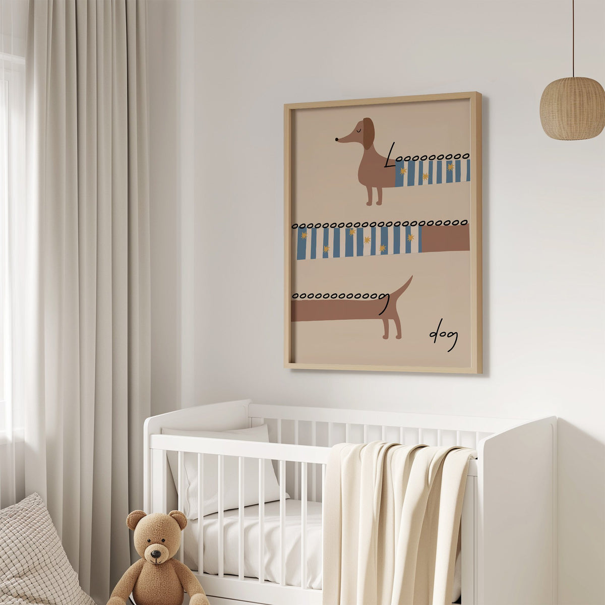 Long dog dachshund sweater nursery print in an oak frame above a white crib with a teddy bear