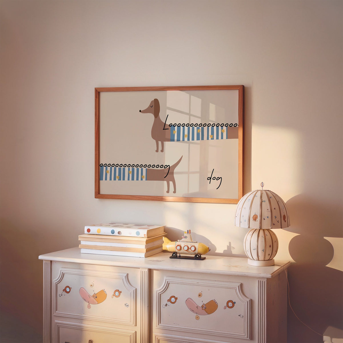 Landscape long dog dachshund sweater nursery print in a cherry wood frame above a painted dresser and lamp