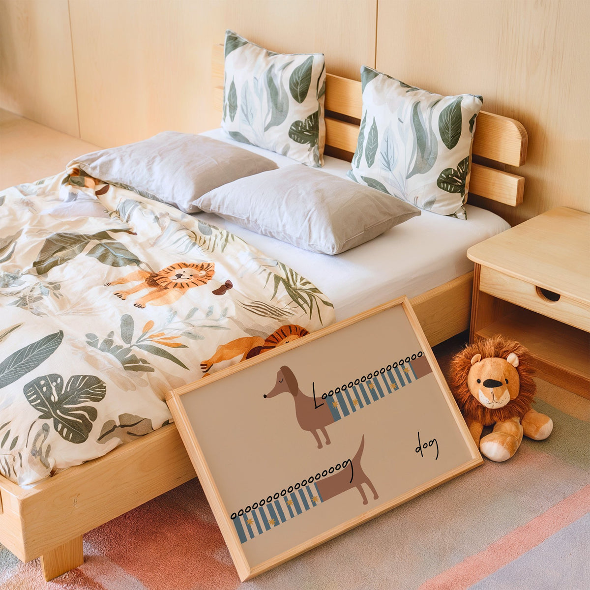 Landscape long dog dachshund sweater nursery print in an oak frame leaning on a kids bed by a lion plush
