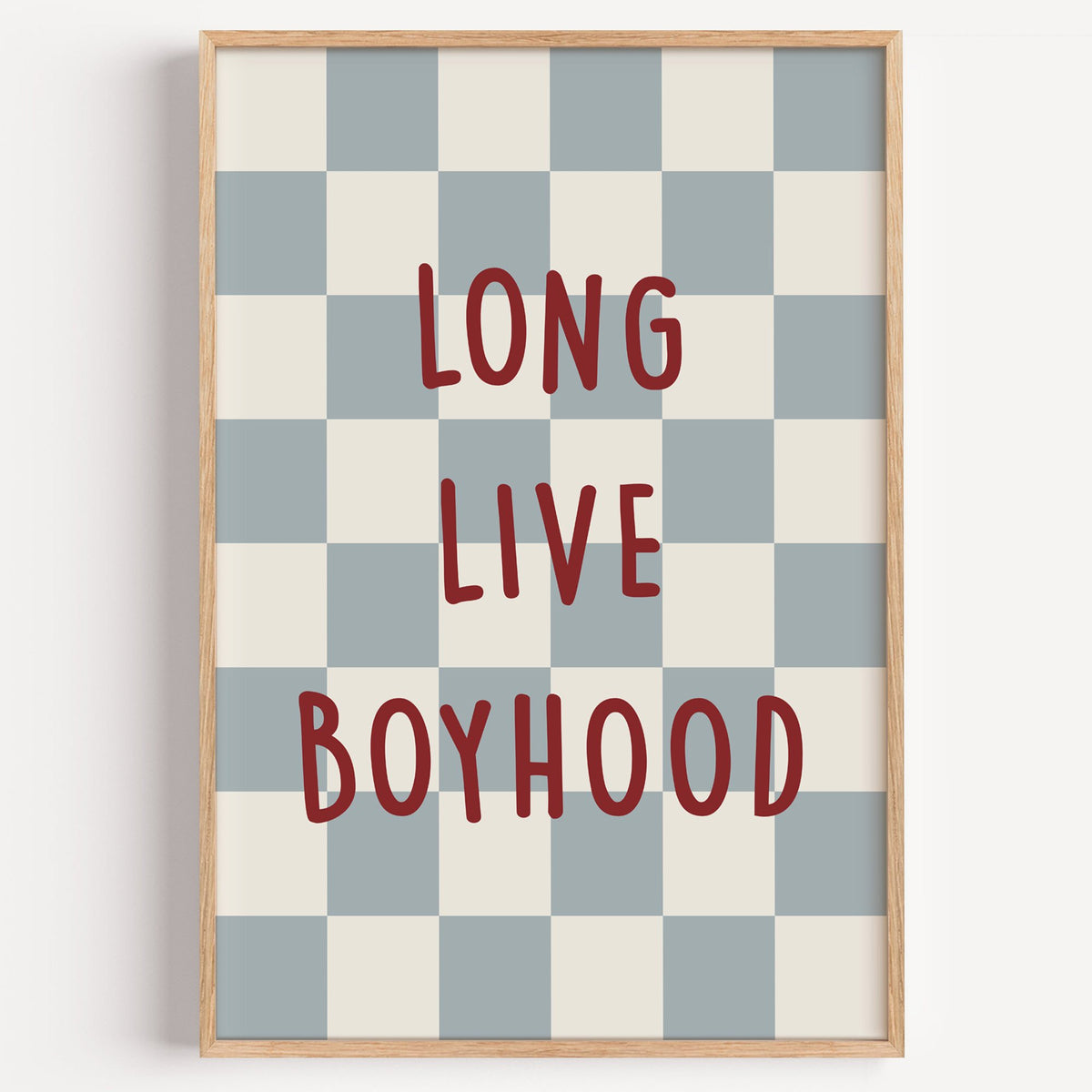 Long live boyhood checker nursery print in a light oak frame on a plain white wall