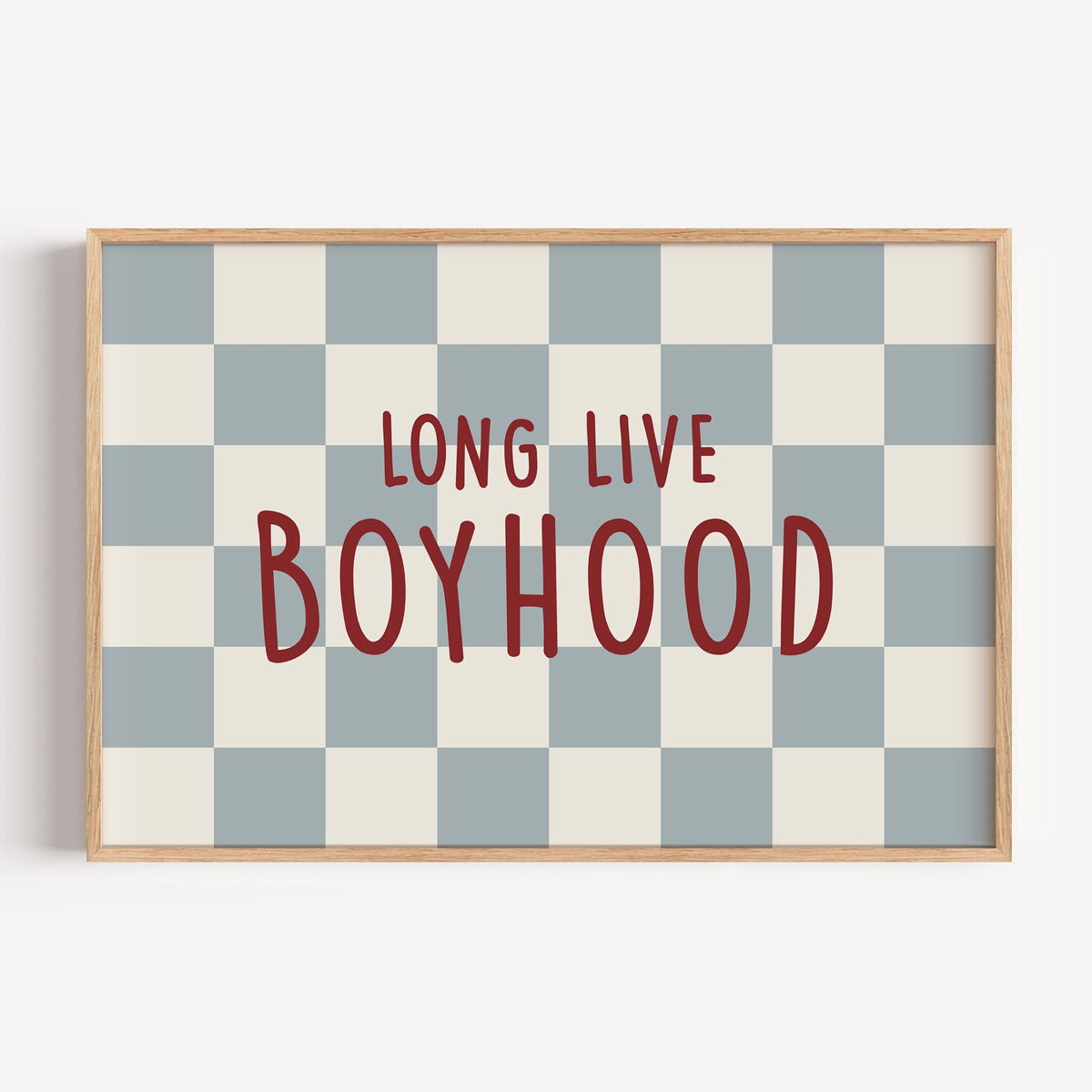 Landscape long live boyhood checker nursery print in a light oak frame on a plain white wall