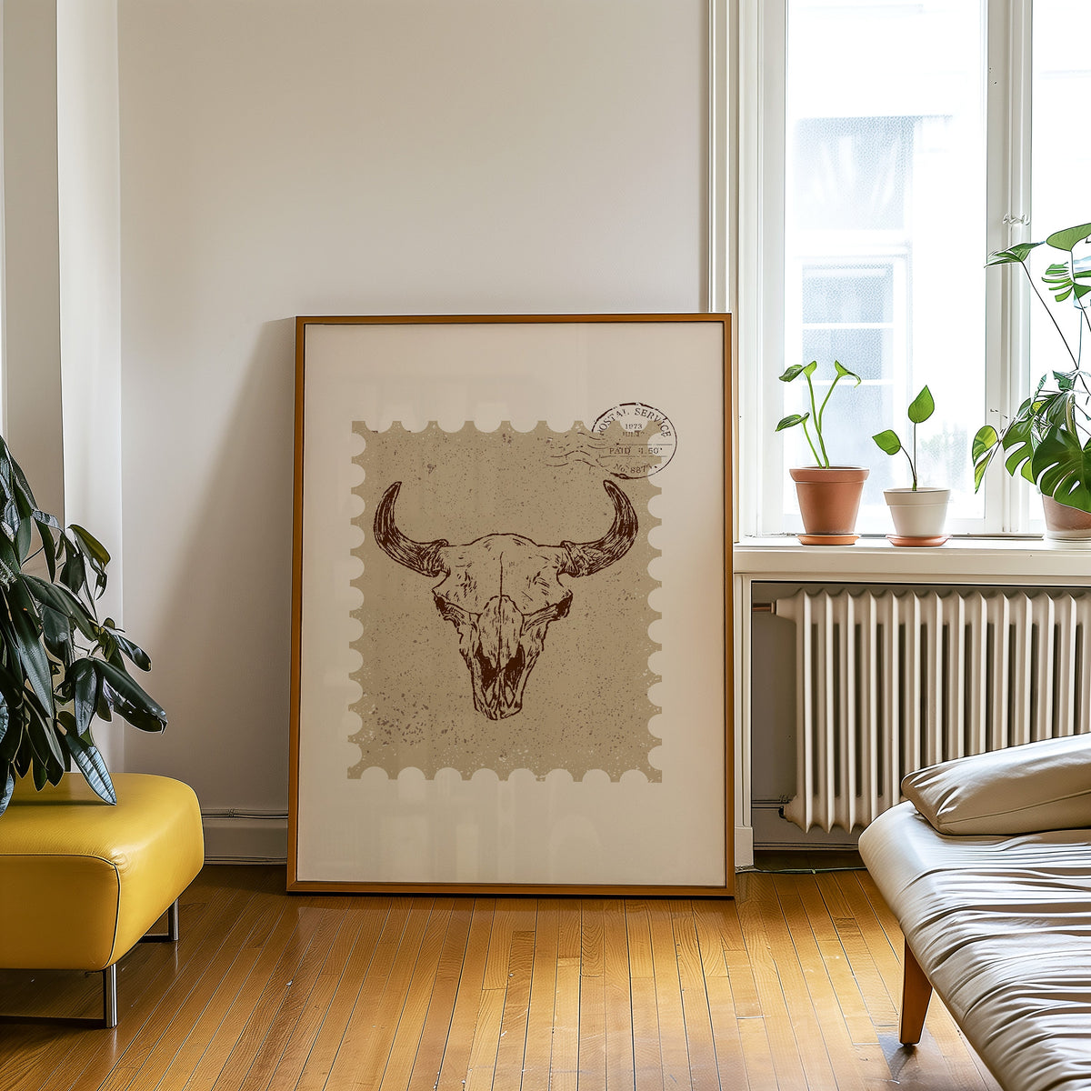 Longhorn skull stamp print in an oak frame on a parquet floor beside a yellow bench