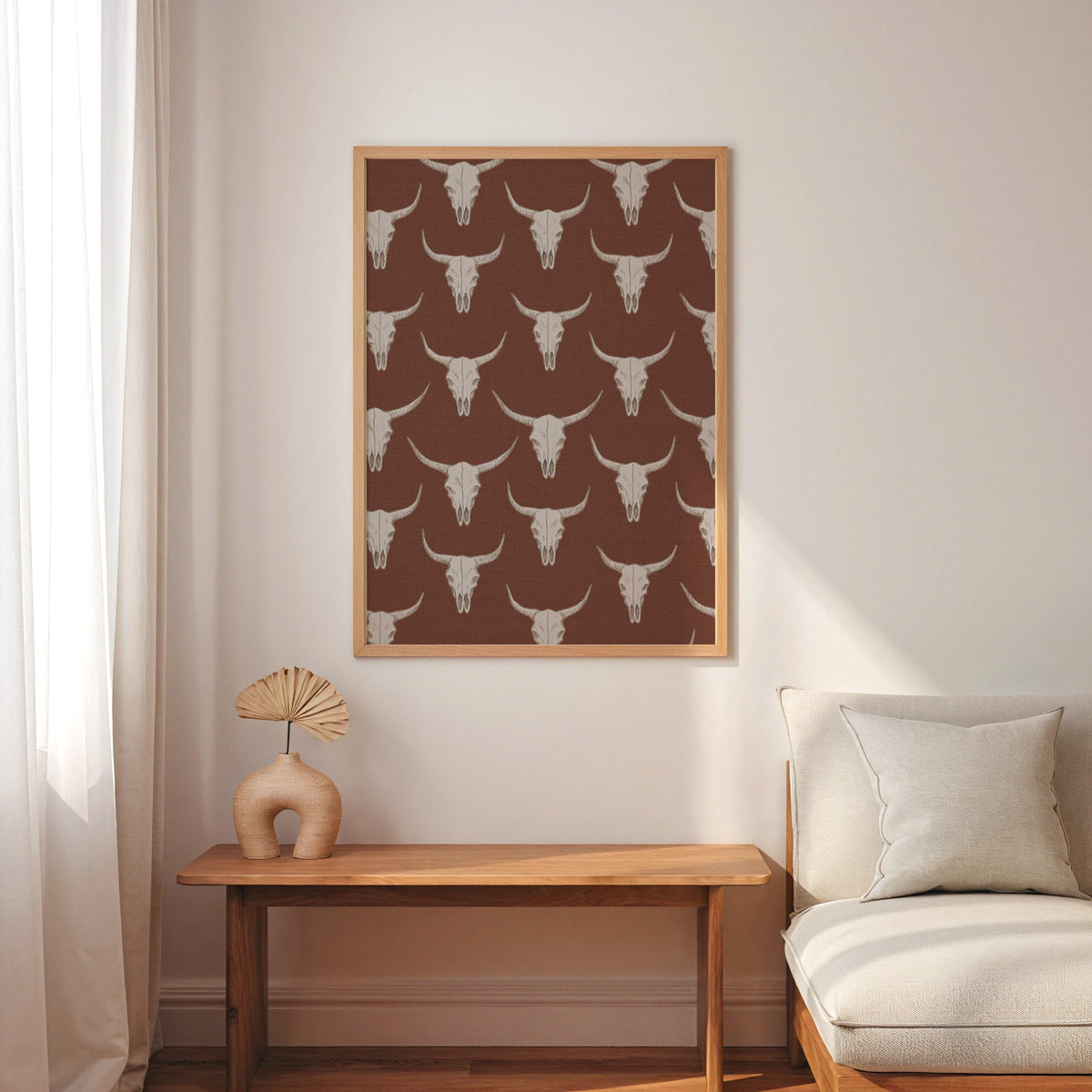 Longhorn skull pattern print in an oak frame above a console with an arch vase