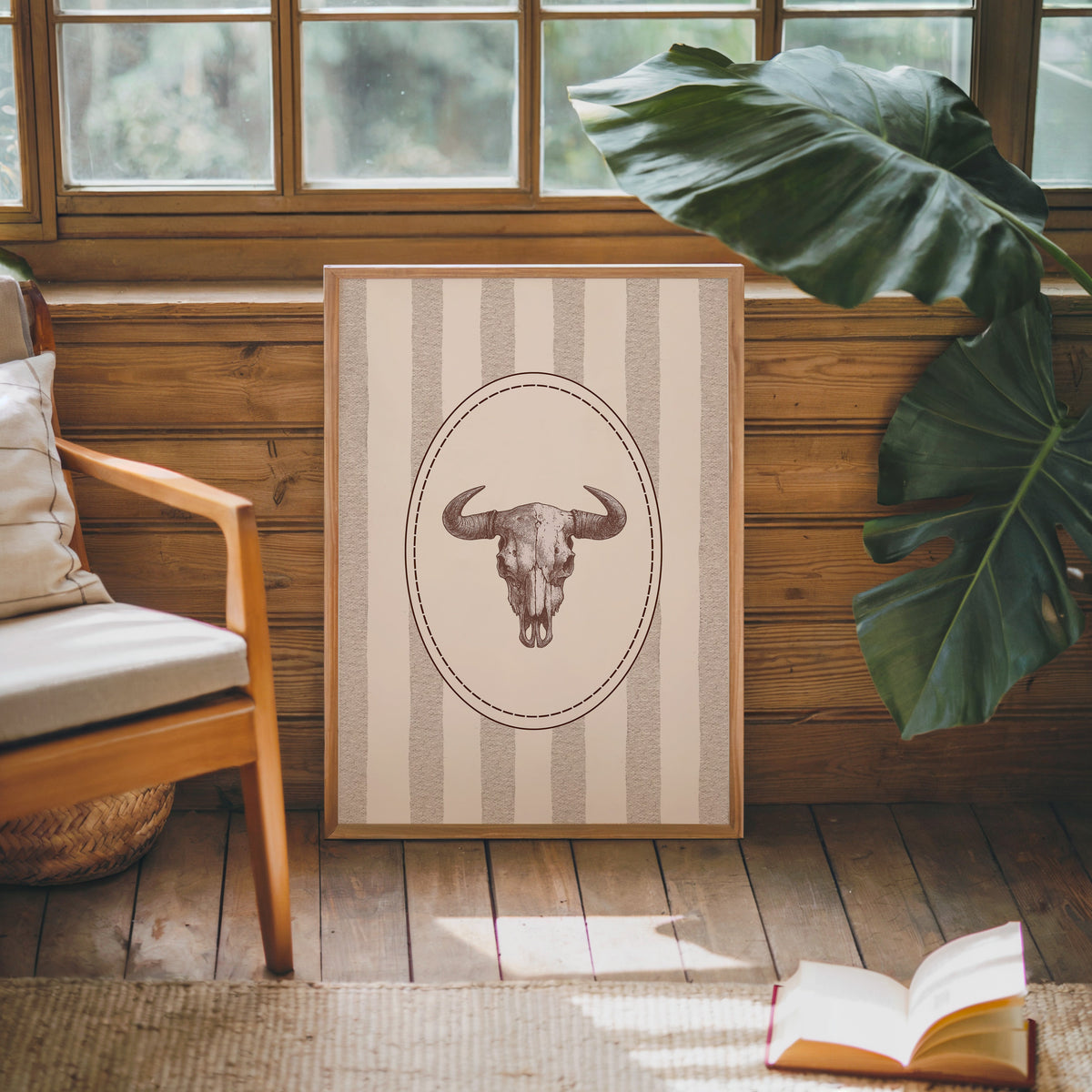 Longhorn skull cameo print in an oak frame against a wood panel cabin wall