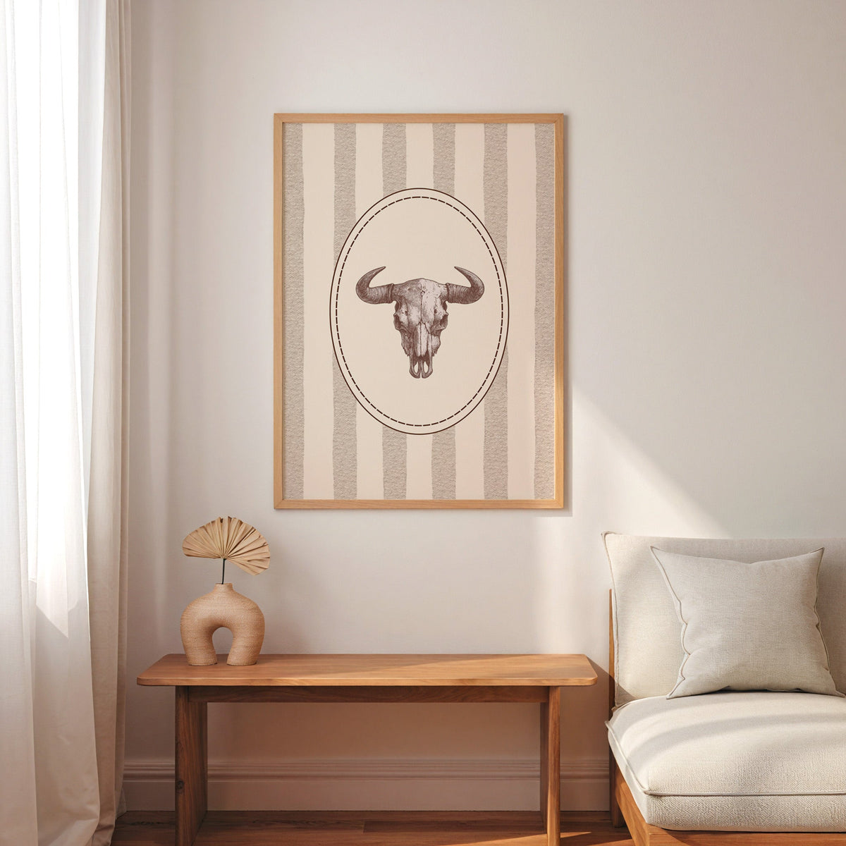 Longhorn skull cameo print in an oak frame above a console with an arch vase