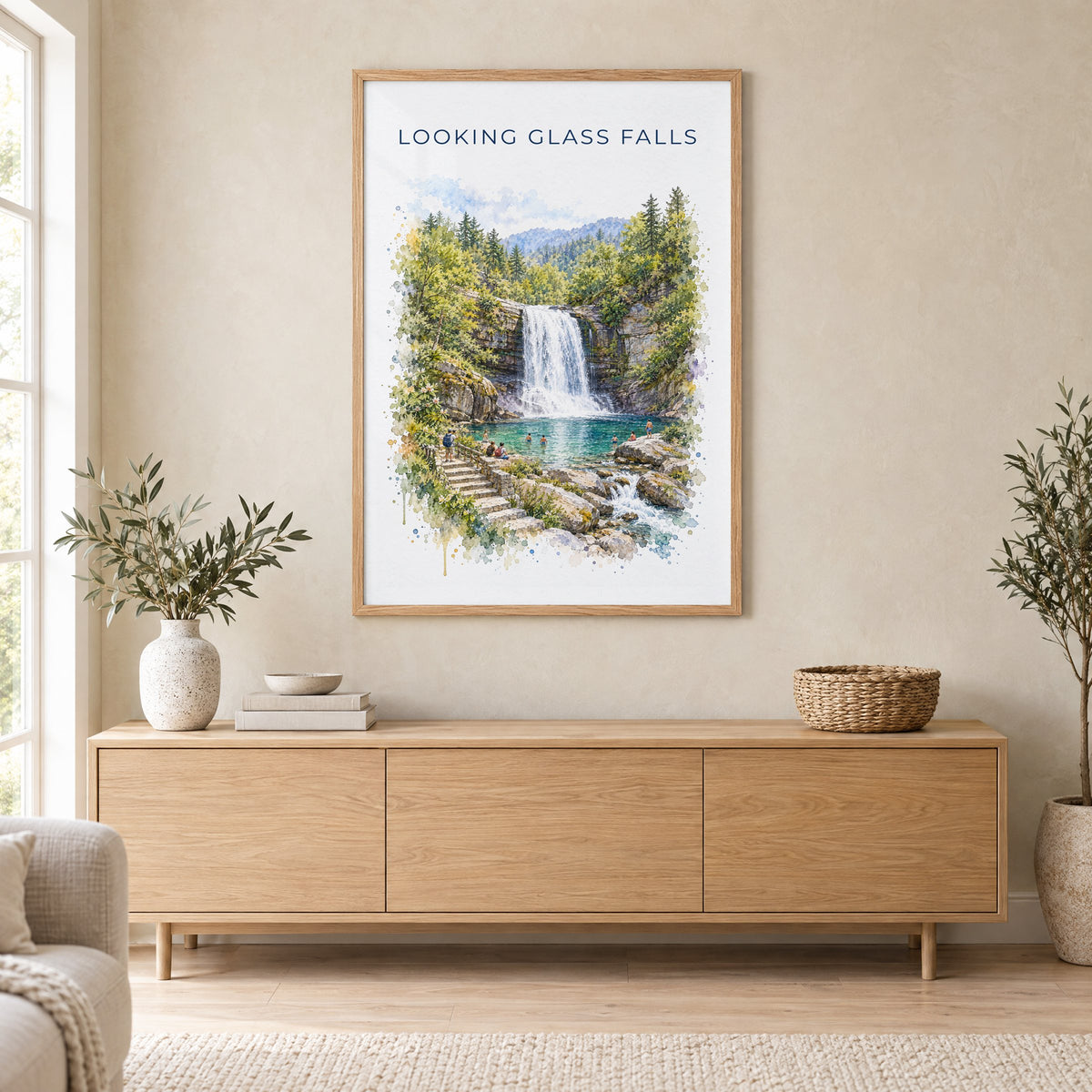 Looking Glass Falls watercolor print in an oak frame above a light wood sideboard in a Scandinavian living room