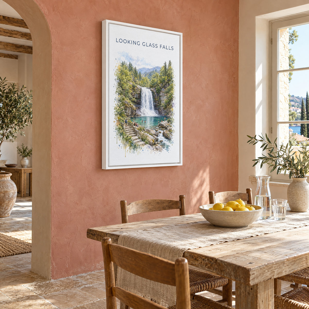 Looking Glass Falls watercolor print as a white floater canvas on a terracotta wall above a rustic dining table