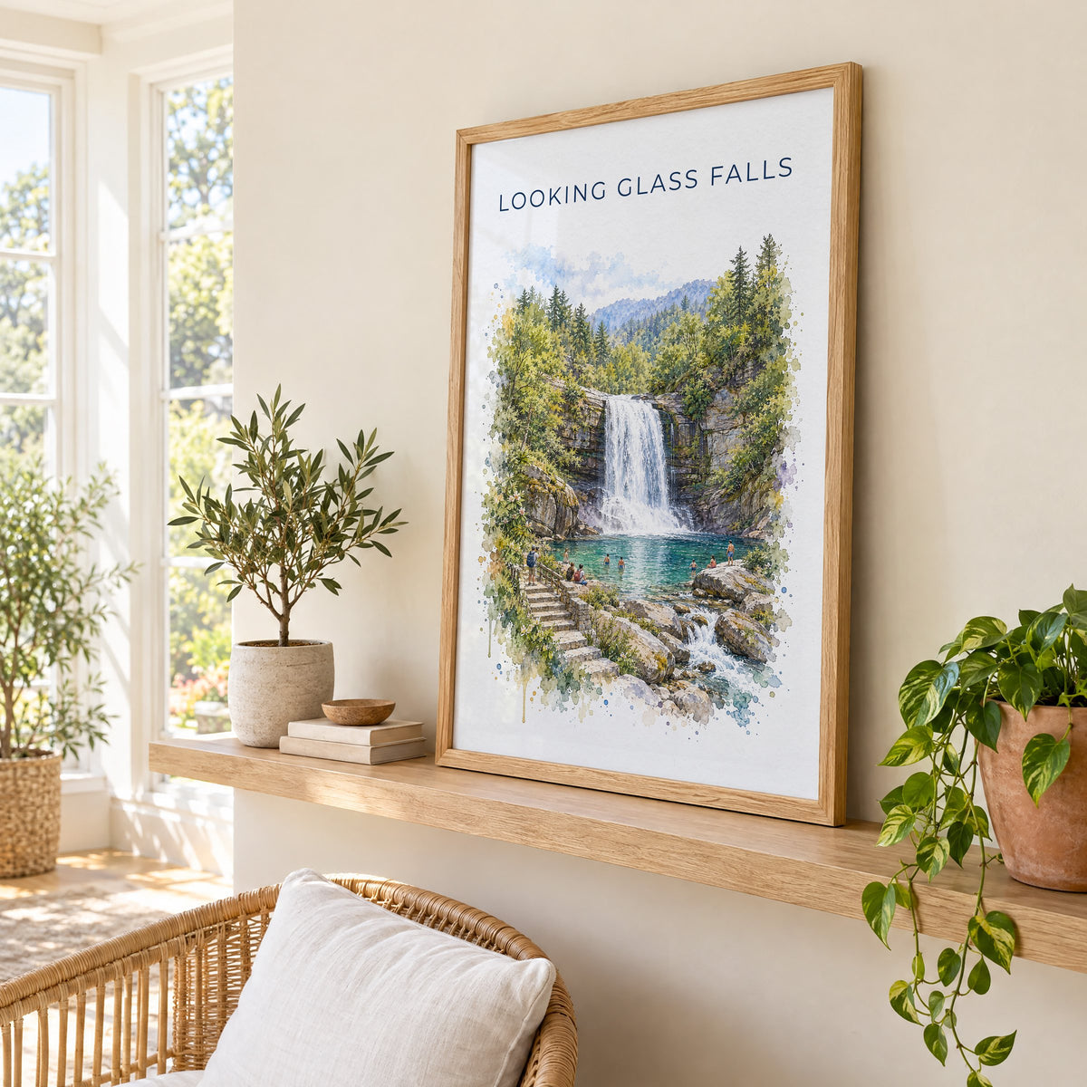 Looking Glass Falls watercolor print in an oak frame on a picture ledge in a sunlit sunroom